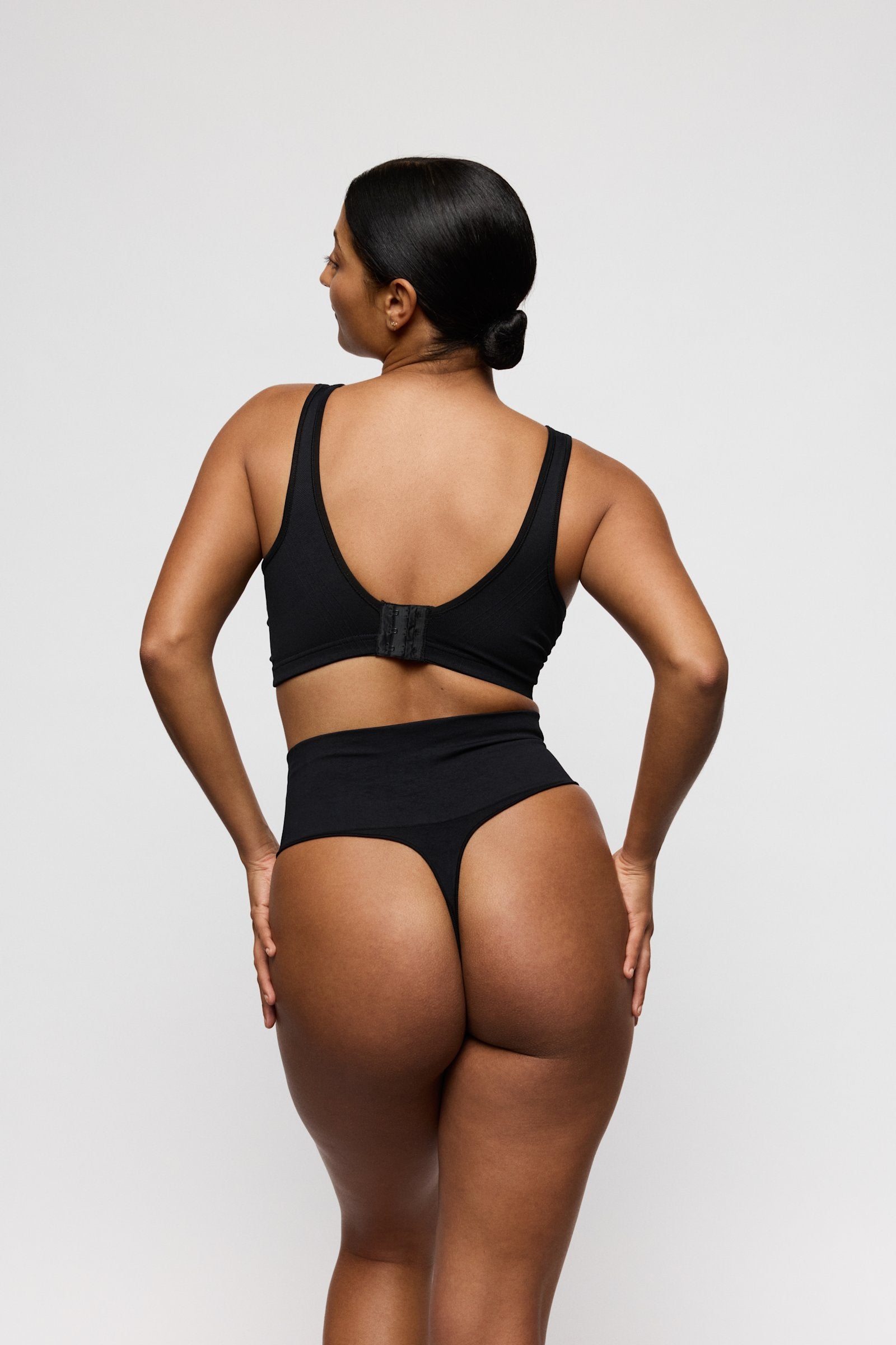 PrimaDonna Nudda Shapewear Thong on model in Black